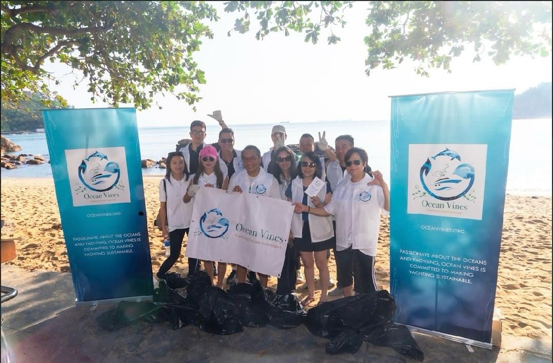 Ocean Vines volunteers in Hong Kong after a beach cleanup, holding the Save The Ocean banner